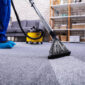 Human Cleaning Carpet In The Living Room Using Vacuum Cleaner At Home