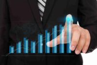 Business man pressing high tech type of modern graph on a virtual background