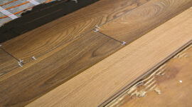 Renovation works. Close-up of installation of parquet and ceramic tile floor and heating cables for warm floor.