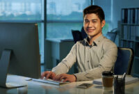 Portrait of cheerful Filipino businessman  at his workplace